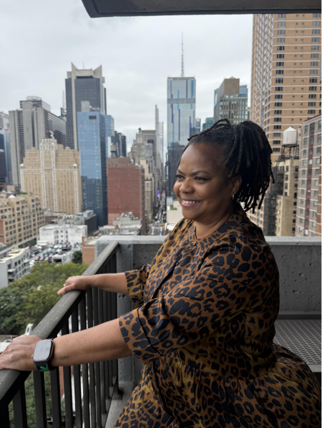 Dr. Denise Bolds on a balcony overlooking New York City